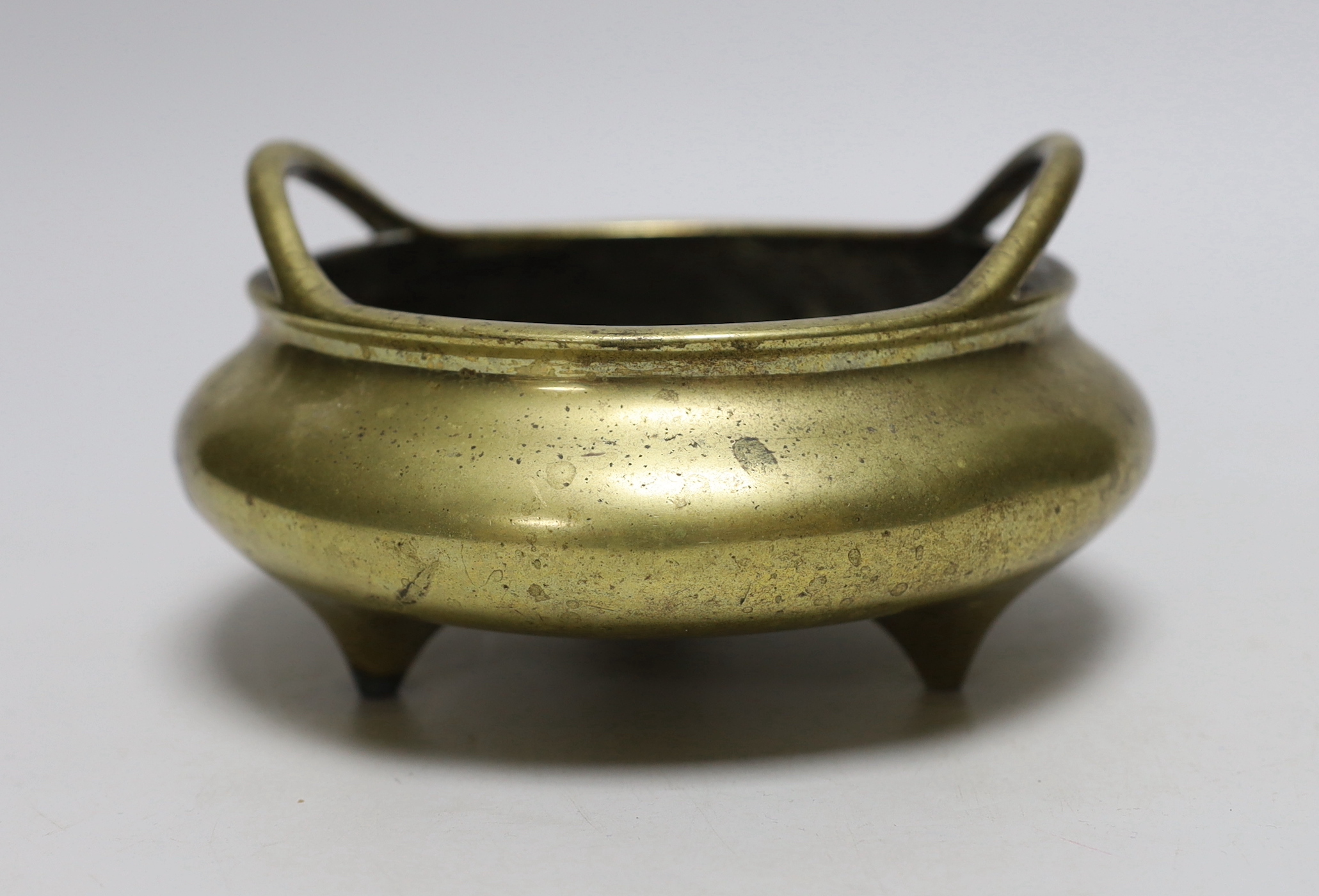 A late 19th century Chinese bronze censer with twin handles, apocryphal Xuande mark, 17.5cm in diameter